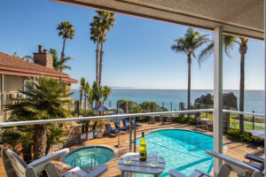 Inn at the Cove pool and palm trees